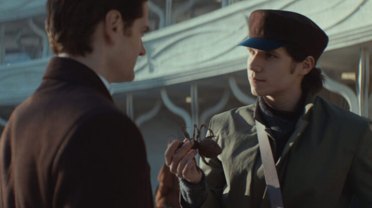 Syril talking to Samm covertly in Palmo's central square in Andor season 2, week 2