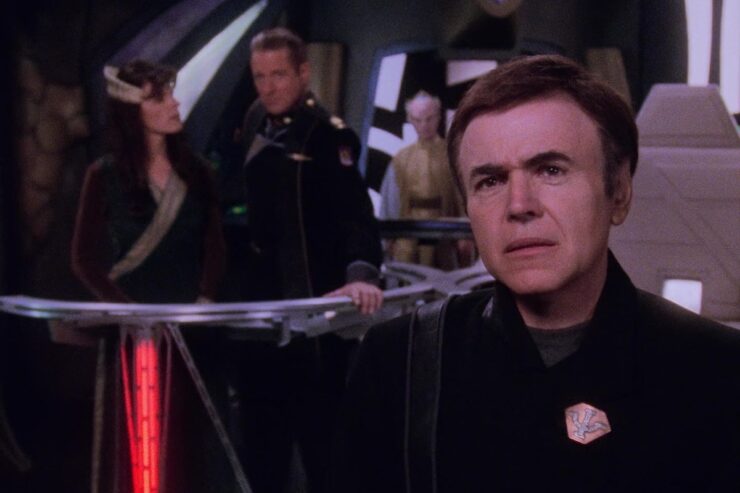 Bester (Walter Koenig) stands in front of Delenn and Sheridan in a scene from Babylon 5: "Epiphanies"