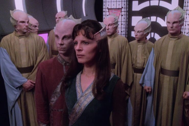 Lennier, Delenn, and several other Minbari in a scene from Babylon 5: "Rumors, Bargains, and Lies"