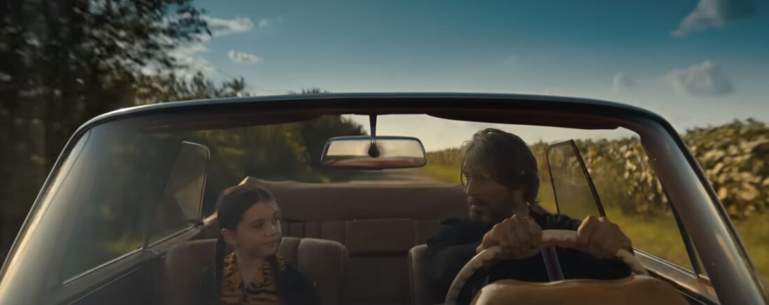 Aurora and 5B driving down a highway, glancing at each other in Dust Bunny