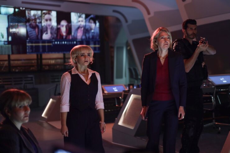 Shirley, Ruby, and Kate all look at Conrad in horror at UNIT HQ in Doctor's Who's "Lucky Day"