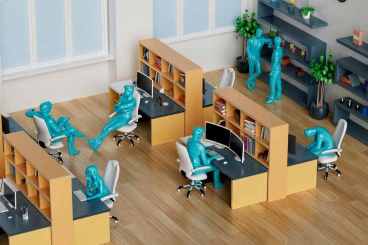 Photo of a model office with several workstations and model workers