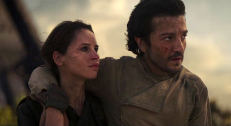 Jyn Erso (Felicity Jones) and Cassian Andor (Diego Luna) stand together during the final scene of Rogue One: A Star Aars Story