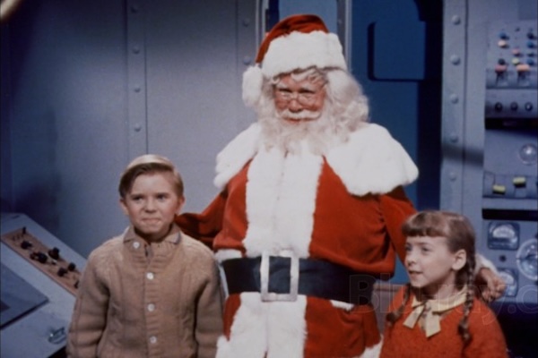 Santa and two earthling children aboard a spaceship in Santa Claus Conquers the Martians