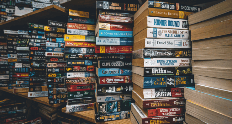 Photo of a shelf with stacks of paperback books