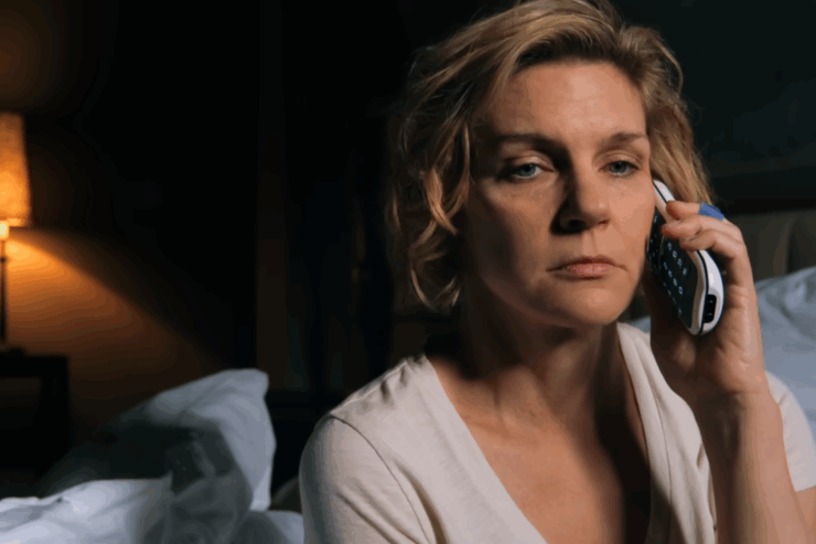 Carol (Rhea Seehorn) answers the phone in a scene from Pluribus